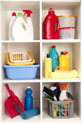 Different cleaning supplies and tools on shelves
