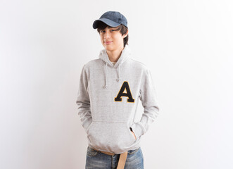Fototapeta premium Handsome boy in a white hoodie on white background.