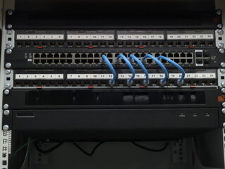 An Ethernet switch and patch panels installed in a low-current rack.