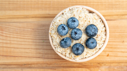 Breakfast cereals in bowl served with  and blueberries. Clean eating, healthy food diet concept