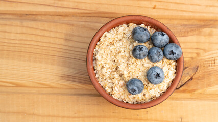 Breakfast cereals in bowl served with  and blueberries. Clean eating, healthy food diet concept