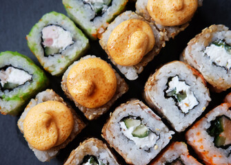 Overhead japanese sushi food. Maki ands rolls with tuna, salmon, shrimp, crab and avocado.