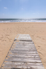 a wooden walkway on the beach of Punta Umbria, Spain. Vacation concept.