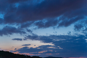 Gloomy rain clouds at sunset.