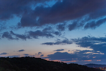 Gloomy rain clouds at sunset.
