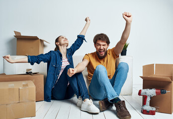 young couple moving family boxes with things