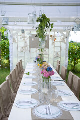 table set in the garden under the gazebo