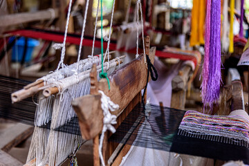 Traditional woven fabric Mae Chaem pattern that has not finished weaving in the loom at Mae Chaem District, Chiang Mai Province, Thailand