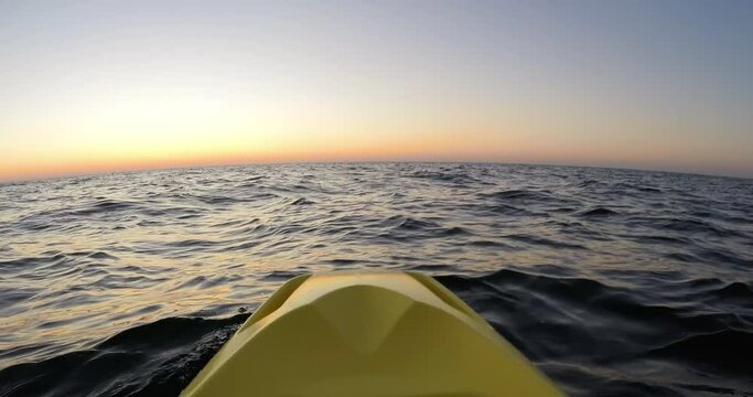 Kayaking at the sunrise in the sea. POV, Wide shot, DCI 4K