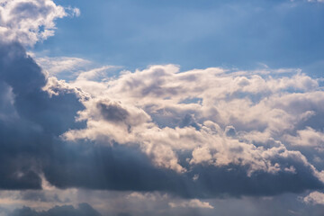 Fototapeta na wymiar Blue sky background with big white tiny stratus cirrus striped clouds