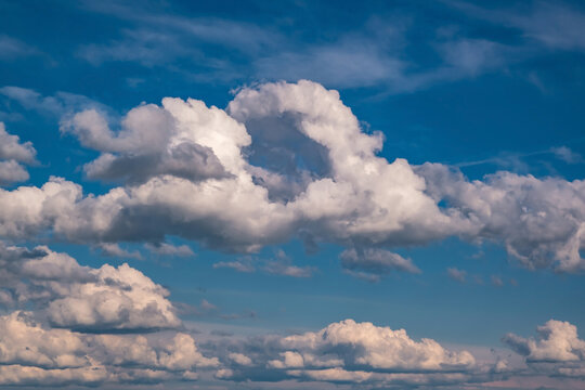 Blue sky background with big white tiny stratus cirrus striped clouds