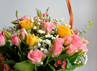 Beautiful bouquet in a basket of different roses.