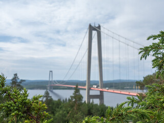 View of Högakustenbron in Sweden with trees in foreground