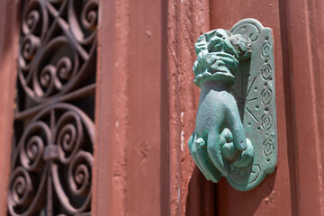 Traditional old door knocker shaped like womans hand