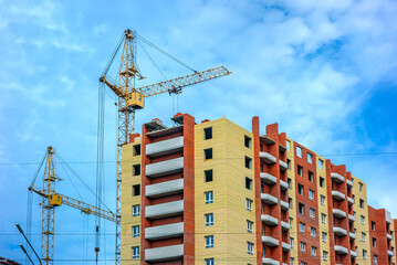 Fototapeta premium Architecture. Construction of a new multi-storey brick house.