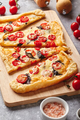 Puff pastry tart with cherry tomatoes, mozzarella and purple basil