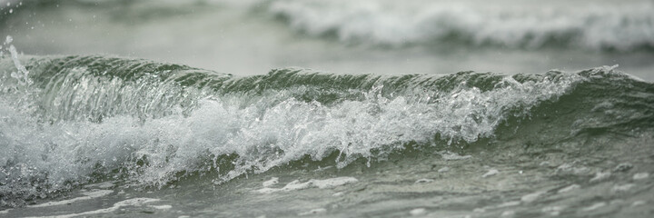 Close up of sea wave in pleasant blue and green tones low angle view water background. Summer...
