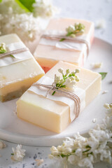 Ecological lilac soap for body care. White aromatic soap.
