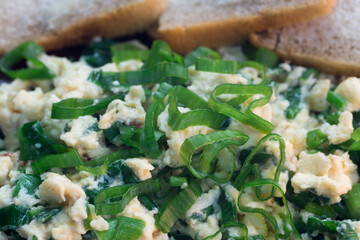 Scrambled eggs with chives on plate