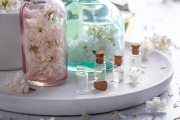 Obraz na płótnie Canvas Unique glass with flower lilac oil. Lilac aromatic oils.