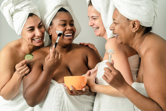 Happy multiracial women with different age and body size having skin care spa day - People selfcare concept