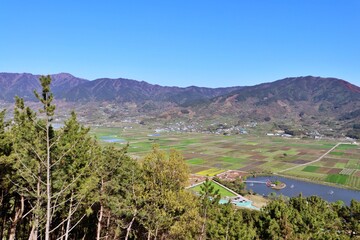 view of the field and village in the mountains