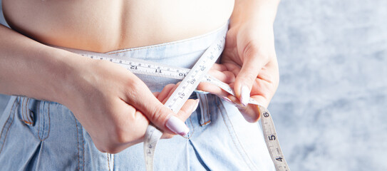 young girl measures abdominal girth