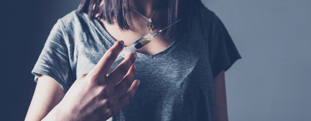 young woman holding a syringe