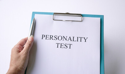 Woman holding a pen with personality test on clipboard. On white background.