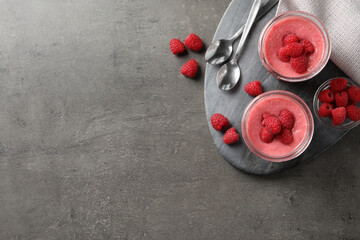 Delicious raspberry mousse served on grey table, flat lay. Space for text