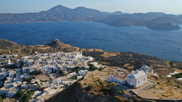 Aerial drone photo from uphill Venetian castle and small chapel overlooking the Aegean sea on top of scenic cliff in chora, capital of Milos island, Cyclades, Greece