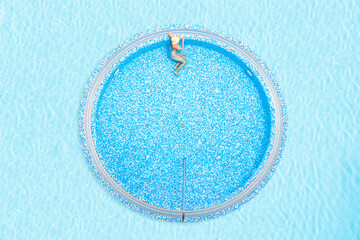 Young alone beautiful sports woman in bikini and hat is swimming in hydro massage bath. Aerial...
