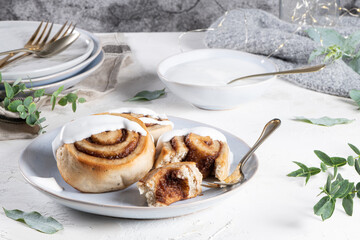 Cinnamon rolls or cinnabon  with icing for Christmas. Homemade traditional winter festive dessert buns. Pastry food for breakfast on white background