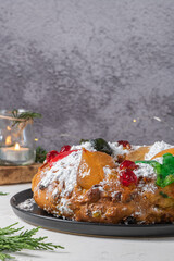 Bolo Rei or King's Cake is a traditional Xmas cake with fruits raisins nut and icing  on kitcthen countertop. Is made for Christmas, Carnavale or Mardi Gras