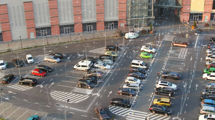 Aerial view of city parking lot with 3D graphic holographic lines on vacant places. Traveling navigation app online. Transport application.