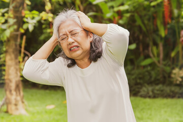 Elderly Asian woman in her 60's had a severe headache exacerbated her hand in pain, was suffering...