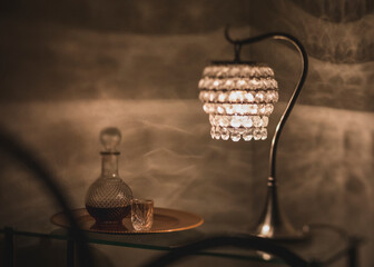 Romantic sherry decanter and glass at night with dramatic light