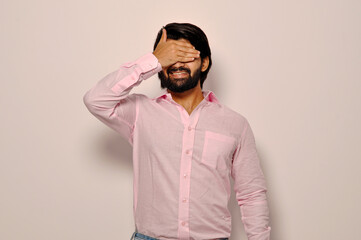 Man wearing Formal shirt smiling and laughing with hand on face covering eyes for surprise. blind concept.
