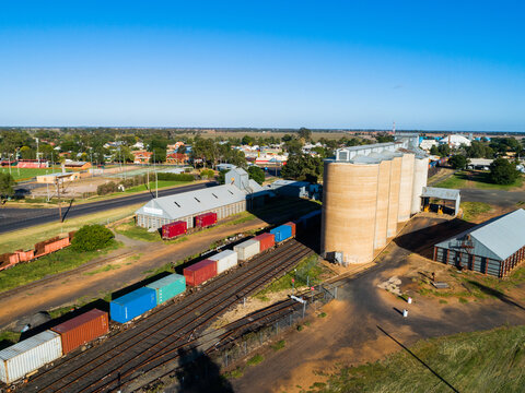 Aussie country town scene in Narromine of grain silos beside railway and freight train