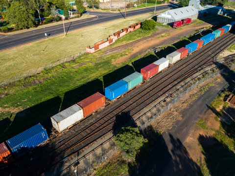 Aerial view of containers on a freight train in small Aussie town