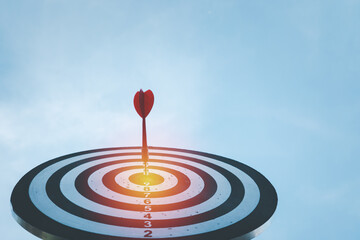 Close up shot red darts arrows in the target ,arrow hitting the center of a shooting target for...