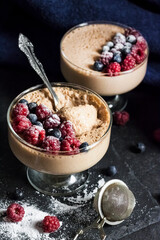 Ryazhenka mousse in glass bowls decorated with fresh berries