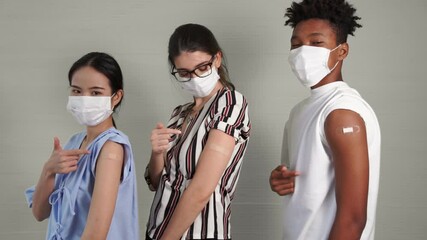 Diverse group of people showing COVID-19 vaccine bandage merrily in concept of coronavirus vaccination program to vaccinate citizen . - Powered by Adobe