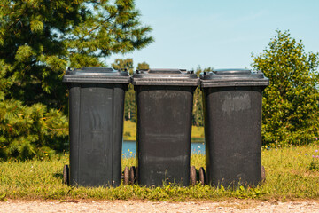 Three plastic waste bins in the city park