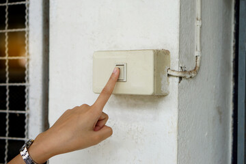Hand turned off light switch before leaving the room or after finish using electric light. Concept...