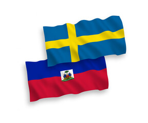 National vector fabric wave flags of Sweden and Republic of Haiti isolated on white background. 1 to 2 proportion.
