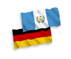 National vector fabric wave flags of Germany and Republic of Guatemala isolated on white background. 1 to 2 proportion.