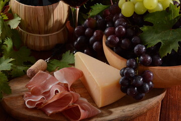 Antipasto with grape, cheese and prosciutto, , selective focus