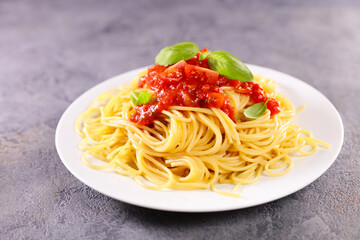 plate of spaghetti with tomato sauce and basil