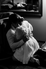 Bride and groom on their wedding day Kissing together on the armchair